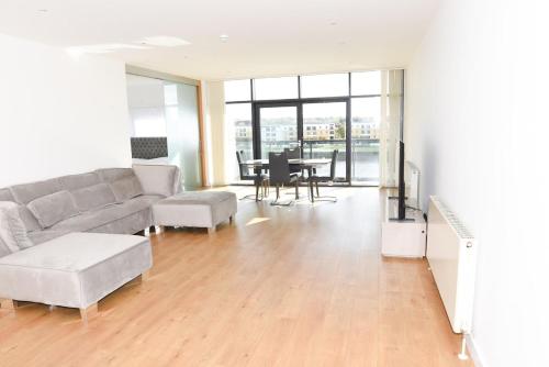 a living room with a couch and a table at Glasgow Hydro Apt with Great Views in Glasgow