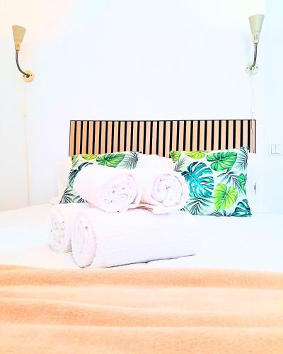 a bed with towels and pillows on it at Easy4Stay in Portimão
