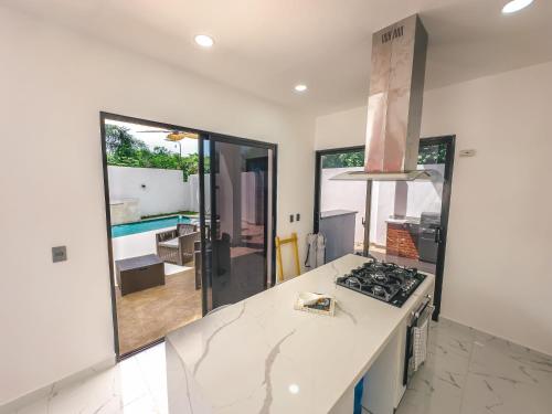 a kitchen with a white counter top and a stove at Stunning Brand New Villa in Downtown Punta Cana in Punta Cana