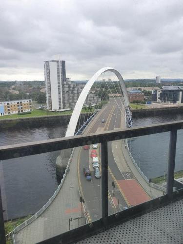 a bridge over a river with cars on a highway at Glasgow Hydro Apt with Great Views in Glasgow