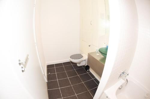 a small bathroom with a toilet and a sink at Glasgow Hydro Apt with Great Views in Glasgow