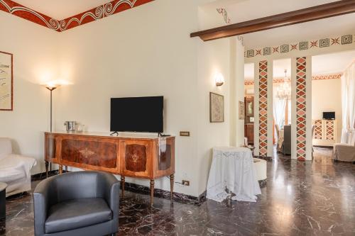 a living room with a tv and a chair at Villa Irini in Altopascio
