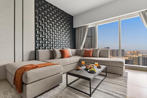 a living room with a couch and a table at Desert Key - Platinum Apartments in Gate Tower, Al Reem Island in Abu Dhabi