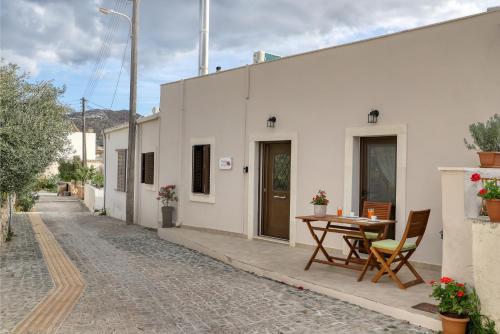 a patio with a table and chairs next to a building at Rodi House by Comfortbnb, Sitia-Palekastro in Palekastron