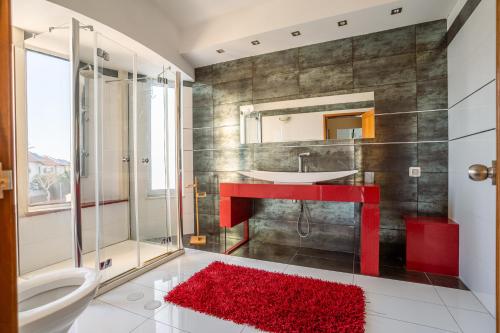 a bathroom with a red sink and a mirror at Villa Yuka- Luxurious Villa in Eilat