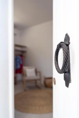 a door handle with a rope hanging from it at Peaceful Lindos in Lindos