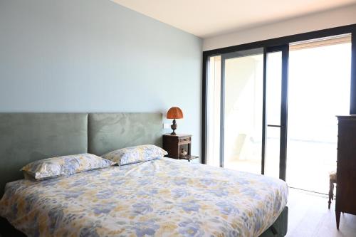 a bedroom with a bed and a large window at CN003 - Cesenatico, bilocale fronte mare con terrazzo panoramico in Cesenatico
