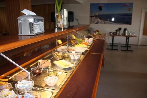 a buffet line with plates of food on it at Molde Vandrerhjem Hostel in Molde