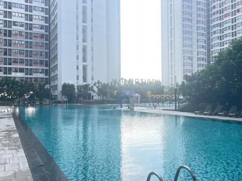a large swimming pool in a city with tall buildings at Holiday like a King and Queen Close to KLIA2 FREE GIFT in Kampong Melot