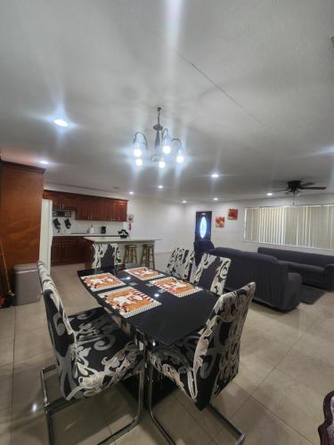a living room with a table and chairs and a couch at The Jazzy Escape in Miami