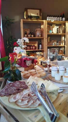 a table with meat and other food on it at Agriturismo Sadira in Calusco dʼAdda