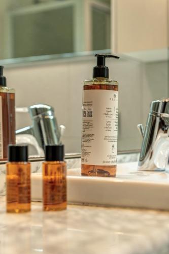 a bathroom sink with two bottles of soap on it at La Torretta by Comorooms in Como