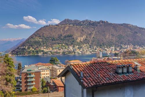 a view of a city and a body of water at La Torretta by Comorooms in Como