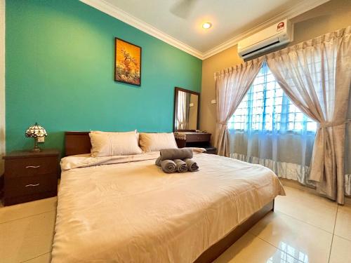 ein Schlafzimmer mit einem Bett, auf dem ein Stofftier liegt in der Unterkunft Kota Laksamana 2-Strey Walk to Jonker Street in Malakka