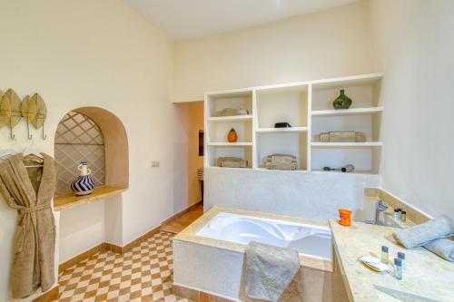 a bathroom with a large tub in a room at Palais Noryalis in Tillouna