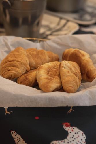 a bunch of croissants sitting on a plate at U-Sense For You Hostel Sevilla in Seville