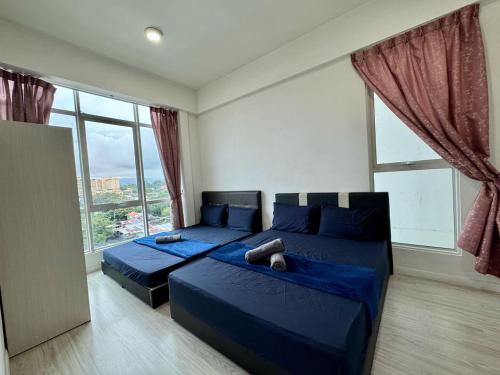 a bedroom with two beds and a large window at SA Sutera Avenue Homestay Opposite Imago KK in Kota Kinabalu