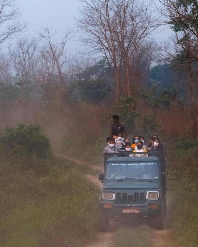 a group of people riding in the back of a jeep at Hong Qi Hotel in Chitwan
