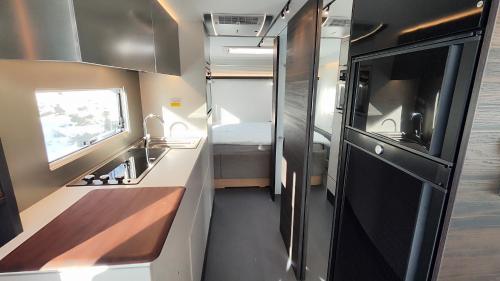 an rv kitchen with a sink and a stove at Northern Lights Camper in Rovaniemi
