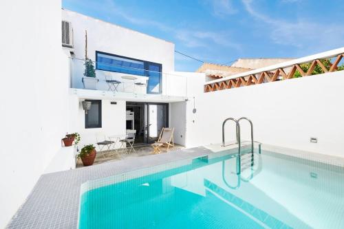 a villa with a swimming pool in front of a house at Casa Chafariz - Casas da Amieira in Amieira