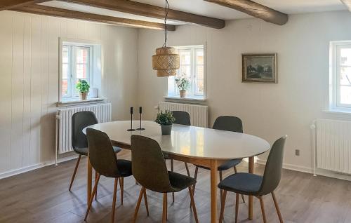 a dining room with a table and chairs at Amazing Home In Silkeborg With Sauna in Silkeborg