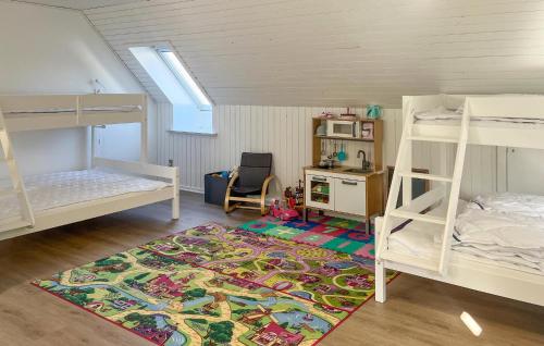 a room with two bunk beds and a rug at Amazing Home In Silkeborg With Sauna in Silkeborg