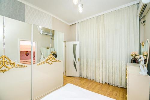 a bathroom with a shower and a glass door at Nizami Central in Baku