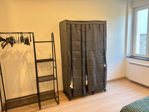 a black cabinet in a room next to a window at Maréchal 1 Parking 4 Couchages in Clouange