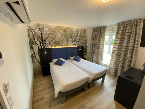 a bedroom with a large bed in a room at Relais Saint Michel in Saint-Michel