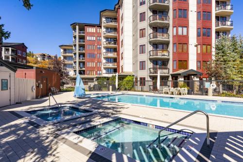 a swimming pool in front of a apartment building at Torian Plum in Steamboat Springs