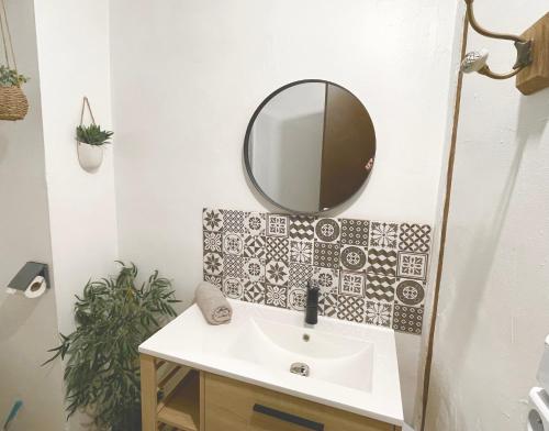une salle de bain avec un lavabo et un miroir au mur dans l'établissement APPARTEMENTS 24h 7j, à Carcassonne