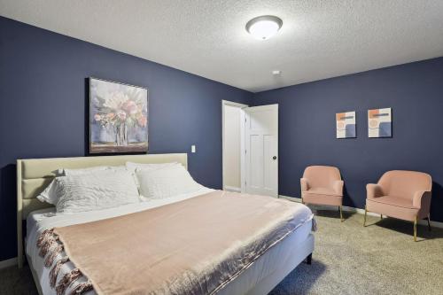 a blue bedroom with a bed and two chairs at Basketball Court, Pickleball, Karaoke, 6 Beds in Minneapolis