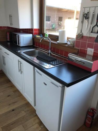 a kitchen with a sink and a counter top at The Granny Anne xe in Blain