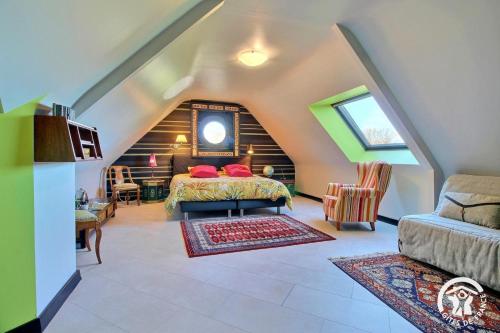 a bedroom with a bed in a attic at Les saudraies - unite familiale in Rieux
