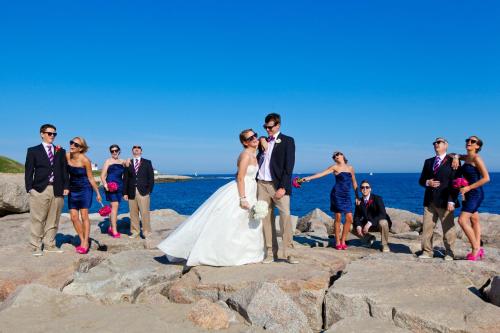 a bride and groom pose for a picture at the beach at Aqua Blue Hotel in Narragansett