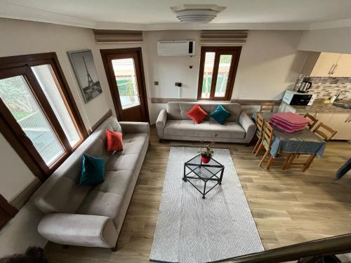 a living room with a couch and a table at İberia Villas in Ortaca