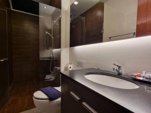 a bathroom with a sink and a toilet and a mirror at Sea Life Poolville in Jomtien Beach