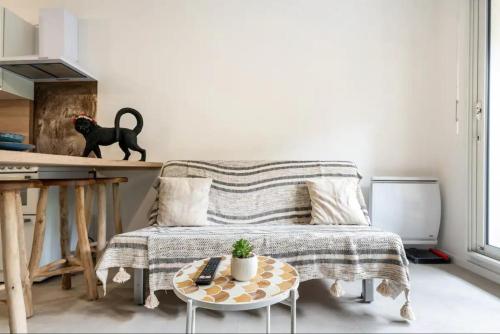 a living room with a couch and a table at Geneva Terrace Apartment in Gaillard