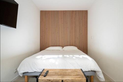 a small bedroom with a bed and a wooden table at Geneva Terrace Apartment in Gaillard