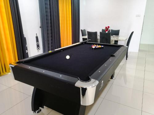 a black pool table with a ball on it at Marvelous Homestay SP Kedah in Sungai Petani