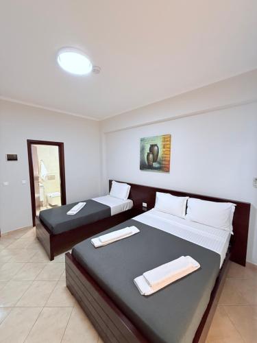 a hotel room with two beds with towels on them at Hotel Milo Ksamil in Ksamil
