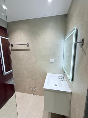 a bathroom with a sink and a shower at Hotel Milo Ksamil in Ksamil