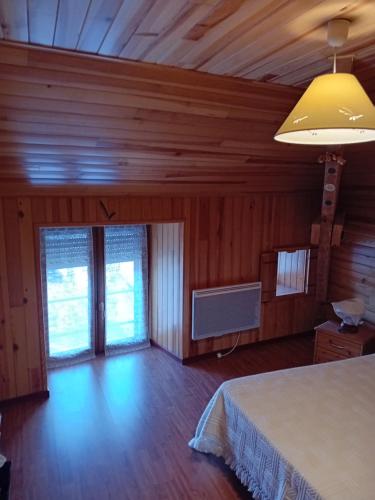 a bedroom with a bed and a yellow lamp at gite D ETAPE DU PELERIN de la butte aux oiseaux in Saint-Alban-sur-Limagnole