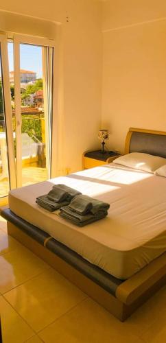 a bedroom with a large bed with a balcony at Francesco's Apartment-Chalkidiki in Flogita