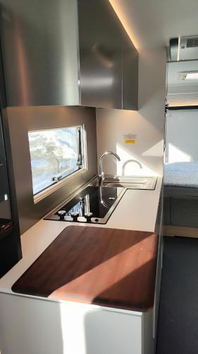 a kitchen with a sink and a counter top at Northern Lights Camper in Rovaniemi
