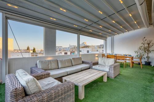 a living room with a couch and chairs on a balcony at Beautiful Penthouse with pool and terrace in Is-Swieqi