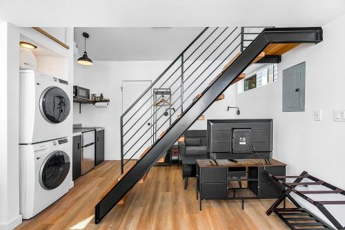 a living room with a staircase in a house at Echo Loft A Modern Escape in Seattle