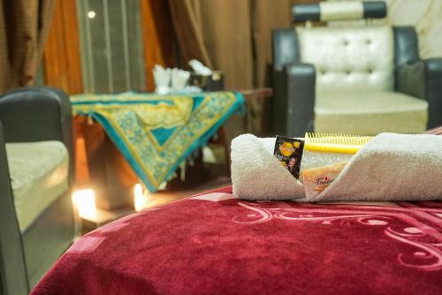 a close up of a bed with towels on it at Hotel the Lodges inn in Multan