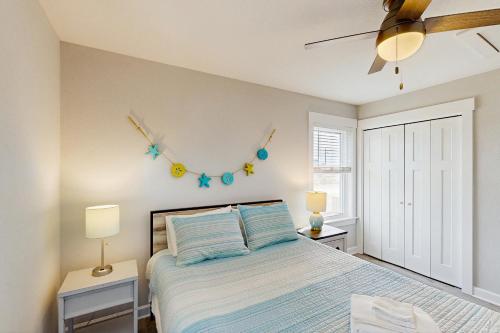 a bedroom with a bed and a clock on the wall at Prickly Pear 723 in Avon