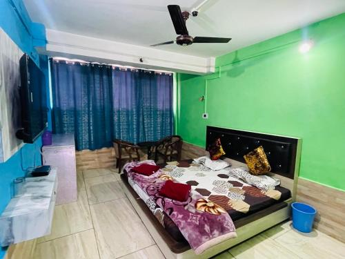 a bedroom with a bed in a room with green walls at New Sahil in Srinagar